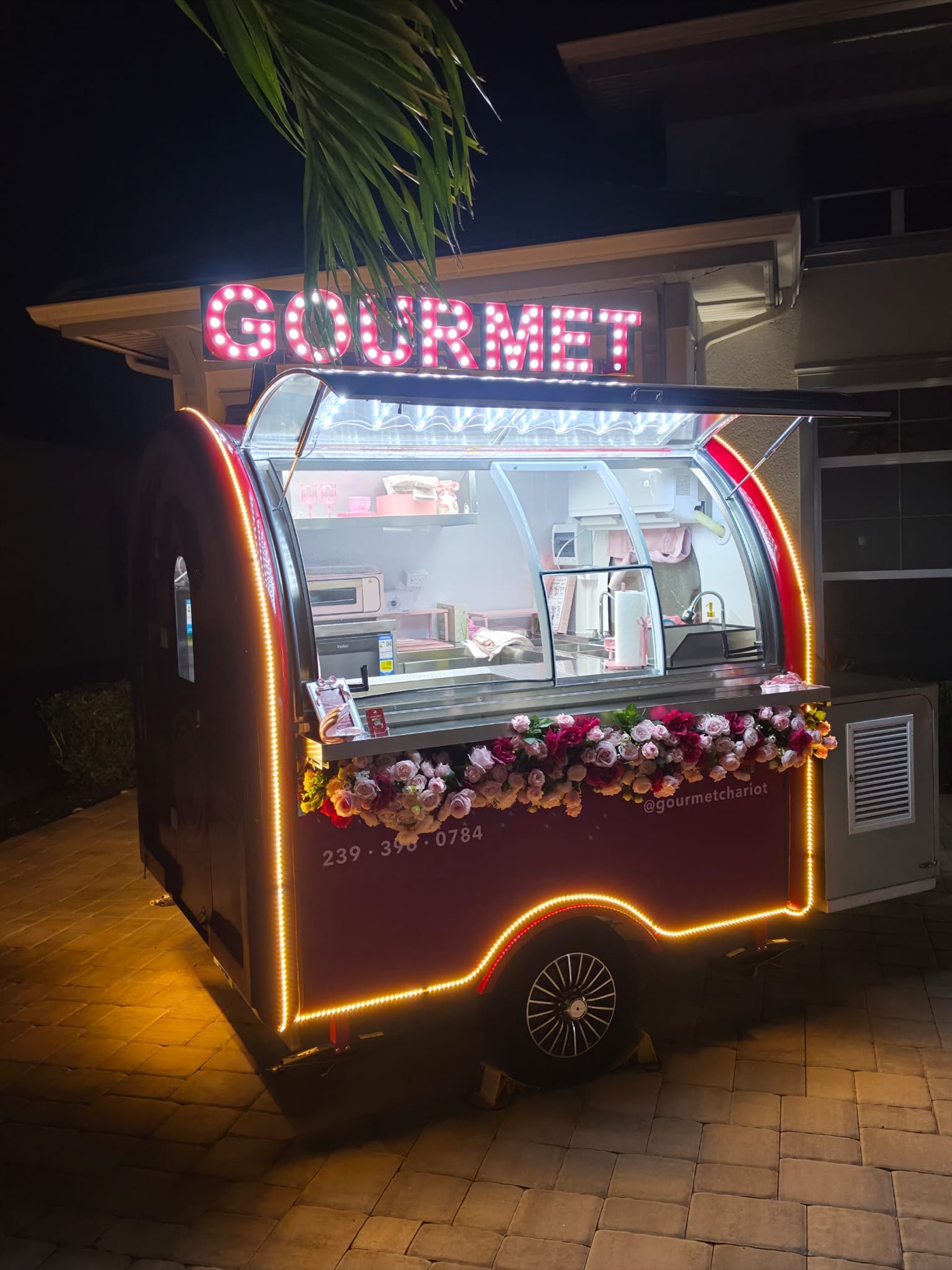 The Chariot at night in Naples, marquee lit and the body outlined in warm light