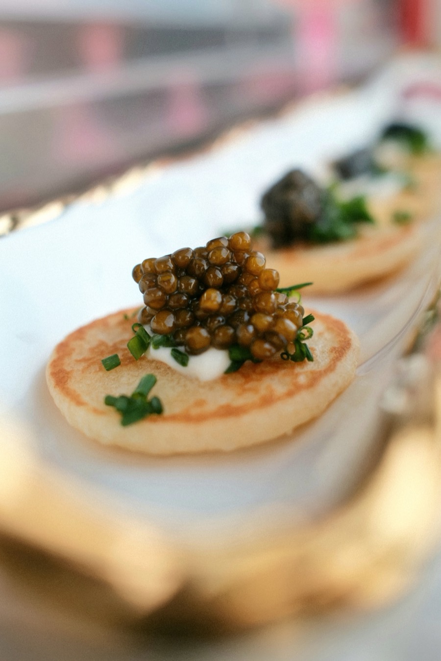 Warm blini with crème fraîche, caviar and chive